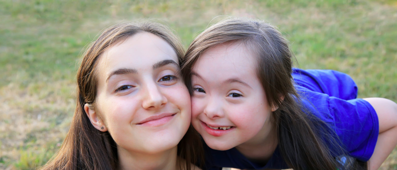 Two people smiling at the camera