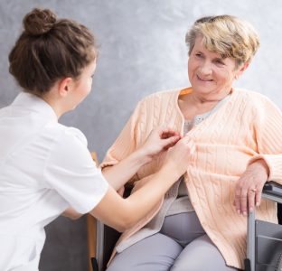 A carer helping a lady dress