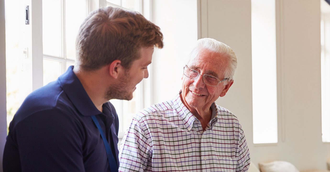 A carer talking to a gentleman