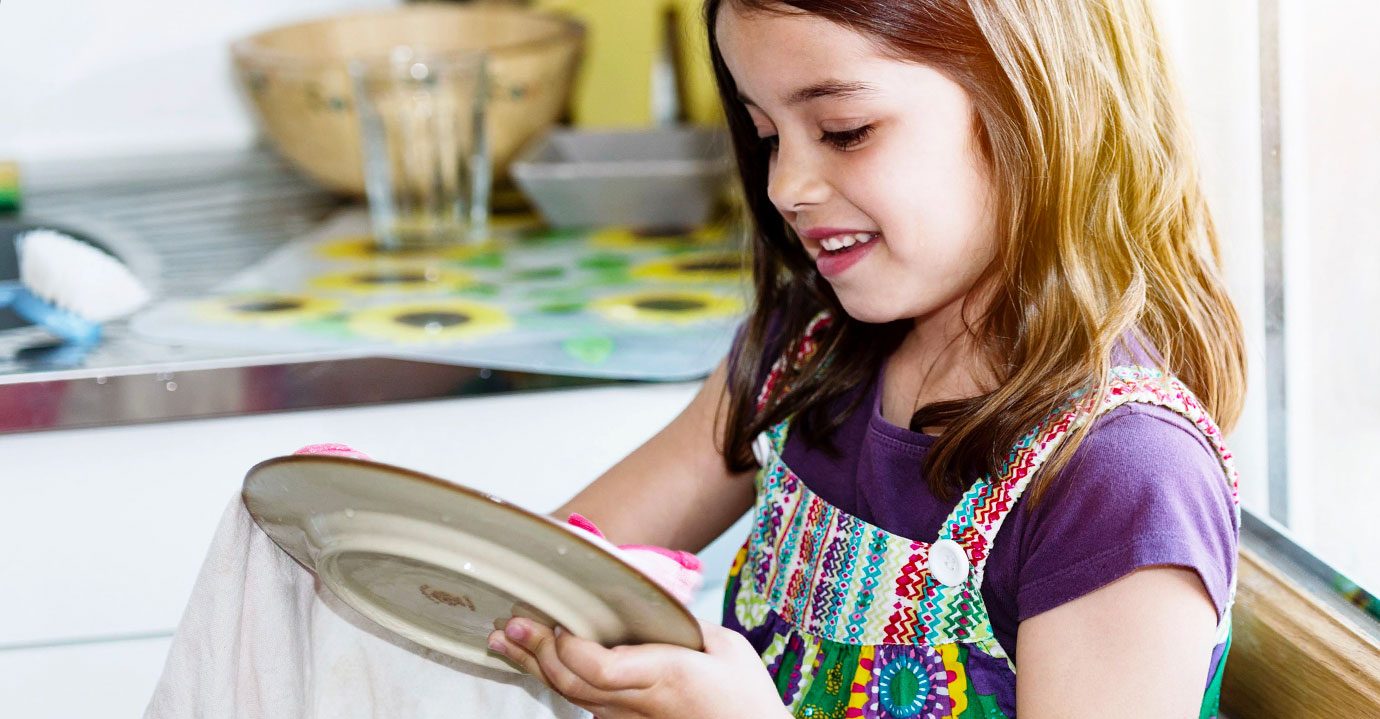 A girl washing the dishes