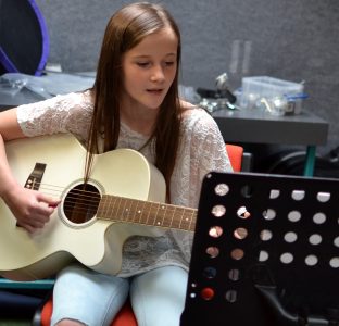 A girl playing the guitar