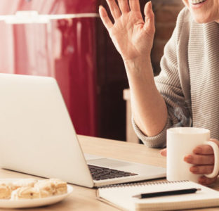 Using a laptop whilst drinking a coffee