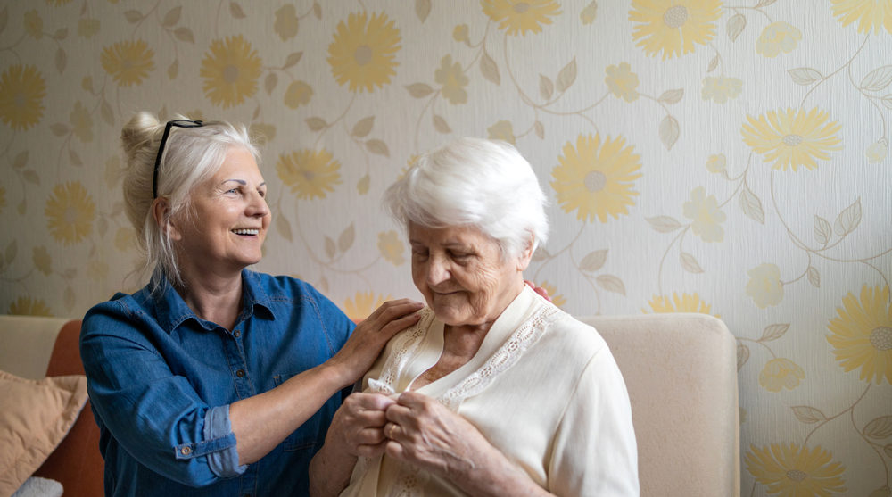 Carer helping elderly mother