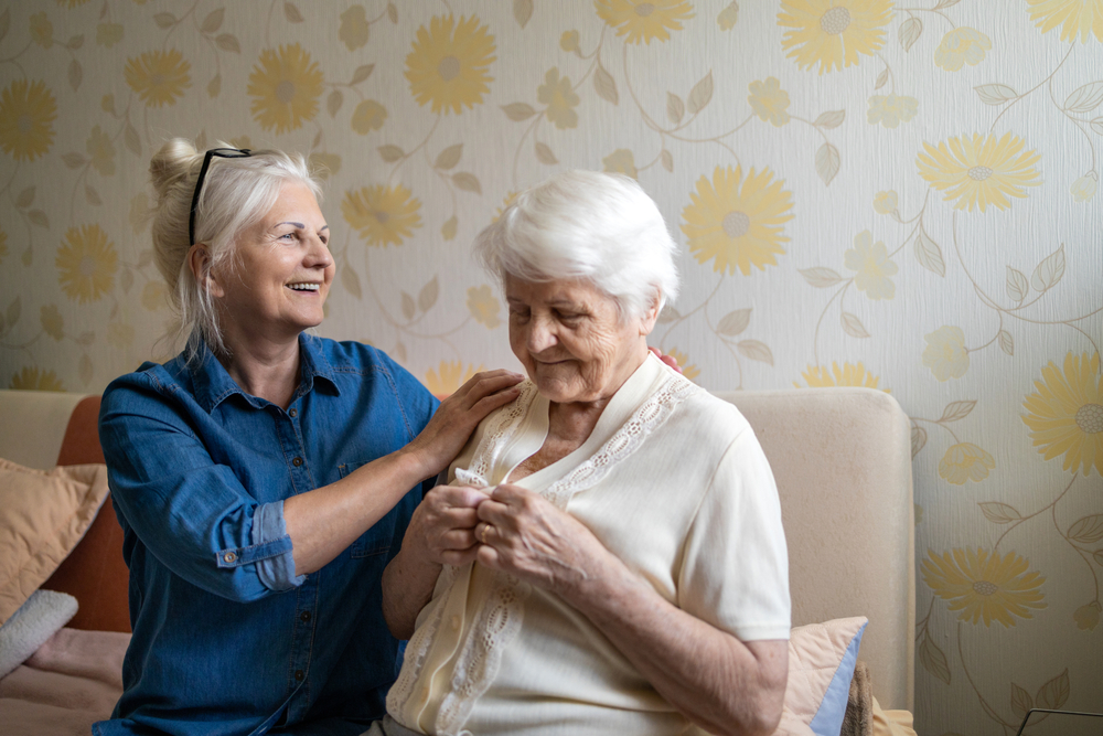 Carer helping elderly mother