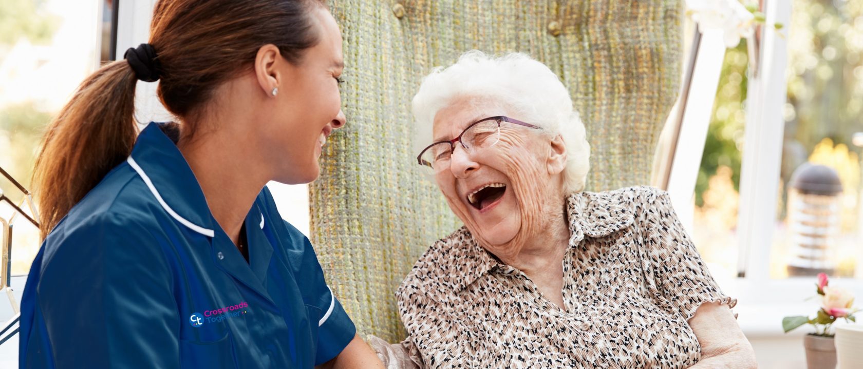 Support worker caring for elderly woman