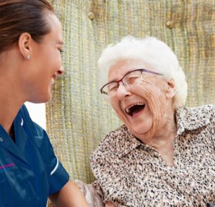 Support worker caring for elderly woman